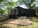 Landscaped backyard with a patio set on a brick pad and green lawn at 1051 S Brady Ave, Newton, NC 28658