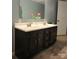 Bathroom featuring a double sink vanity with dark wood cabinets and a large mirror at 1051 S Brady Ave, Newton, NC 28658