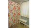 Cozy bathroom featuring a shower with floral curtain and a small white bench by the window at 1051 S Brady Ave, Newton, NC 28658