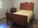 Bedroom with a decorative wood headboard, dresser and wood-look floors at 1051 S Brady Ave, Newton, NC 28658