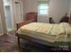Bedroom showcasing a patterned quilt and walk-in closet access at 1051 S Brady Ave, Newton, NC 28658