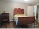 Bedroom with a decorative wood headboard and a dresser with a unicorn statue at 1051 S Brady Ave, Newton, NC 28658