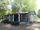 Charming home with a covered parking area, front porch, and flag display at 1051 S Brady Ave, Newton, NC 28658