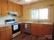 Cozy kitchen featuring wood cabinets, modern appliances and a sunlit window at 1051 S Brady Ave, Newton, NC 28658