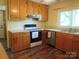 Cozy kitchen featuring wood cabinets, modern appliances and a sunlit window at 1051 S Brady Ave, Newton, NC 28658