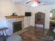 Cozy living room featuring a brick fireplace, wood floors, and natural light at 1051 S Brady Ave, Newton, NC 28658