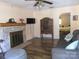 Cozy living room with fireplace, TV, and view into adjacent bedroom at 1051 S Brady Ave, Newton, NC 28658