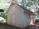 Exterior angle view of the outbuilding with door, window, and rooftop ventilation at 1051 S Brady Ave, Newton, NC 28658