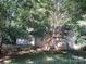 Exterior view of the outbuilding surrounded by trees at 1051 S Brady Ave, Newton, NC 28658