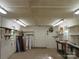 Outbuilding's interior with concrete floor, shelves, and door at 1051 S Brady Ave, Newton, NC 28658
