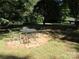 Relaxing outdoor patio area with table and chairs surrounded by lush greenery at 1051 S Brady Ave, Newton, NC 28658