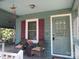 Inviting front porch with seating, decorative shutters, and charming details at 1051 S Brady Ave, Newton, NC 28658