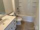 Cozy bathroom featuring a shower-tub combination, and white vanity with tile floors at 10715 Tom Short Rd, Charlotte, NC 28277