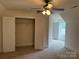 Bedroom featuring a ceiling fan, closet with bi-fold doors, and neutral carpeting at 10715 Tom Short Rd, Charlotte, NC 28277