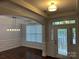 Elegant foyer features hardwood floors, wainscoting, and a decorative chandelier above the dining area at 10715 Tom Short Rd, Charlotte, NC 28277