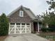 Beautiful home with stone accents, a two-car garage, and a well-maintained front yard at 10715 Tom Short Rd, Charlotte, NC 28277