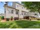 A charming backyard featuring a wooden deck, green lawn, and established landscaping creating an inviting outdoor space at 108 Planters Dr, Statesville, NC 28677