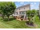 Lovely backyard view with a deck, mature trees, and lush green lawn in a well-maintained residential setting at 108 Planters Dr, Statesville, NC 28677