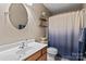 Bathroom with a sink, round mirror, modern decor, wood accents, and a blue-ombre shower curtain at 108 Planters Dr, Statesville, NC 28677