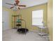 Bright bedroom with yellow walls, a ceiling fan, and a large window providing lots of natural light at 108 Planters Dr, Statesville, NC 28677