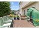 A cozy outdoor deck featuring patio furniture, potted plants, and a small greenhouse for gardening enthusiasts at 108 Planters Dr, Statesville, NC 28677