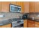Close up of kitchen with stainless steel oven, microwave, and tile backsplash at 108 Planters Dr, Statesville, NC 28677