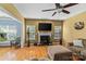Cozy living room featuring hardwood floors, a fireplace and ample natural light at 108 Planters Dr, Statesville, NC 28677
