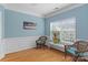 Living room with hardwood floors, ample natural light, fresh paint, and wainscoting at 108 Planters Dr, Statesville, NC 28677