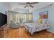 Main bedroom featuring hardwood floors, tray ceiling, sitting area, and good natural light at 108 Planters Dr, Statesville, NC 28677