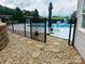 Home's backyard featuring an in-ground pool, fencing, and stone landscaping at 111 Brookview Dr, Shelby, NC 28152