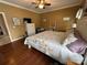 Bedroom with dark wood floors, a ceiling fan, and a king-size bed with a white frame and floral bedding at 111 Brookview Dr, Shelby, NC 28152