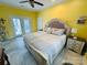 Bright bedroom featuring a ceiling fan, french doors, and a king-size bed with neutral bedding and side tables at 111 Brookview Dr, Shelby, NC 28152