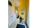 Hallway featuring a doorway to a bathroom, a white door, light fixtures, and decor at 111 Brookview Dr, Shelby, NC 28152