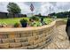 Beautifully landscaped yard with a stone retaining wall and lush, colorful plants at 111 Brookview Dr, Shelby, NC 28152