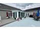 Exterior shot of a spacious covered patio area with seating, grill, and umbrella at 111 Brookview Dr, Shelby, NC 28152