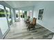 Enclosed sunroom with modern flooring, slider door, and wicker seating at 111 Brookview Dr, Shelby, NC 28152