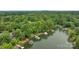 Aerial view of the home's backyard showcasing lake access, dock, and lush greenery at 1111 Palmyra Dr, Fort Mill, SC 29708