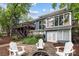 Backyard features a stone patio with Adirondack chairs and lush landscaping, creating a serene outdoor space at 1111 Palmyra Dr, Fort Mill, SC 29708