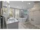Elegant bathroom featuring a soaking tub, tiled shower, and double sink vanity with lots of light at 1111 Palmyra Dr, Fort Mill, SC 29708