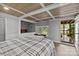 Cozy bedroom featuring a built-in bed nook, wood paneled ceiling, and access to an outdoor deck at 1111 Palmyra Dr, Fort Mill, SC 29708