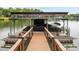 Detail shot of a modern boat dock with covered boat slip, ladders, and seating area at 1111 Palmyra Dr, Fort Mill, SC 29708