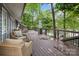 Spacious deck with wicker furniture, a heater, and scenic views of the surrounding lush greenery and the lake at 1111 Palmyra Dr, Fort Mill, SC 29708
