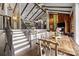 Open concept dining room with staircase leading to living room with a beautiful wood burning fireplace at 1111 Palmyra Dr, Fort Mill, SC 29708