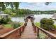 Lake view showing a wooden dock with a covered boat slip on a sunny day at 1111 Palmyra Dr, Fort Mill, SC 29708