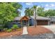 Charming blue home with a welcoming wood porch, beautiful landscaping, and a brown two-car garage at 1111 Palmyra Dr, Fort Mill, SC 29708