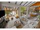 Cozy living room with large glass windows, sunroom and open dining area, perfect for relaxation and entertaining at 1111 Palmyra Dr, Fort Mill, SC 29708
