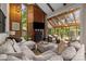 Inviting living room featuring a fireplace, sunroom, comfortable seating, and wood paneled accent walls at 1111 Palmyra Dr, Fort Mill, SC 29708