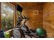 Bright workout room featuring wood paneling, exercise equipment, a television, and a scenic view at 1111 Palmyra Dr, Fort Mill, SC 29708