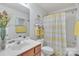 Bright bathroom featuring a single sink vanity and a shower/tub combo at 11218 Grass Field Rd # 1083, Charlotte, NC 28213