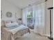 Bright bedroom featuring a window nook with seating and serene decor at 11218 Grass Field Rd # 1083, Charlotte, NC 28213